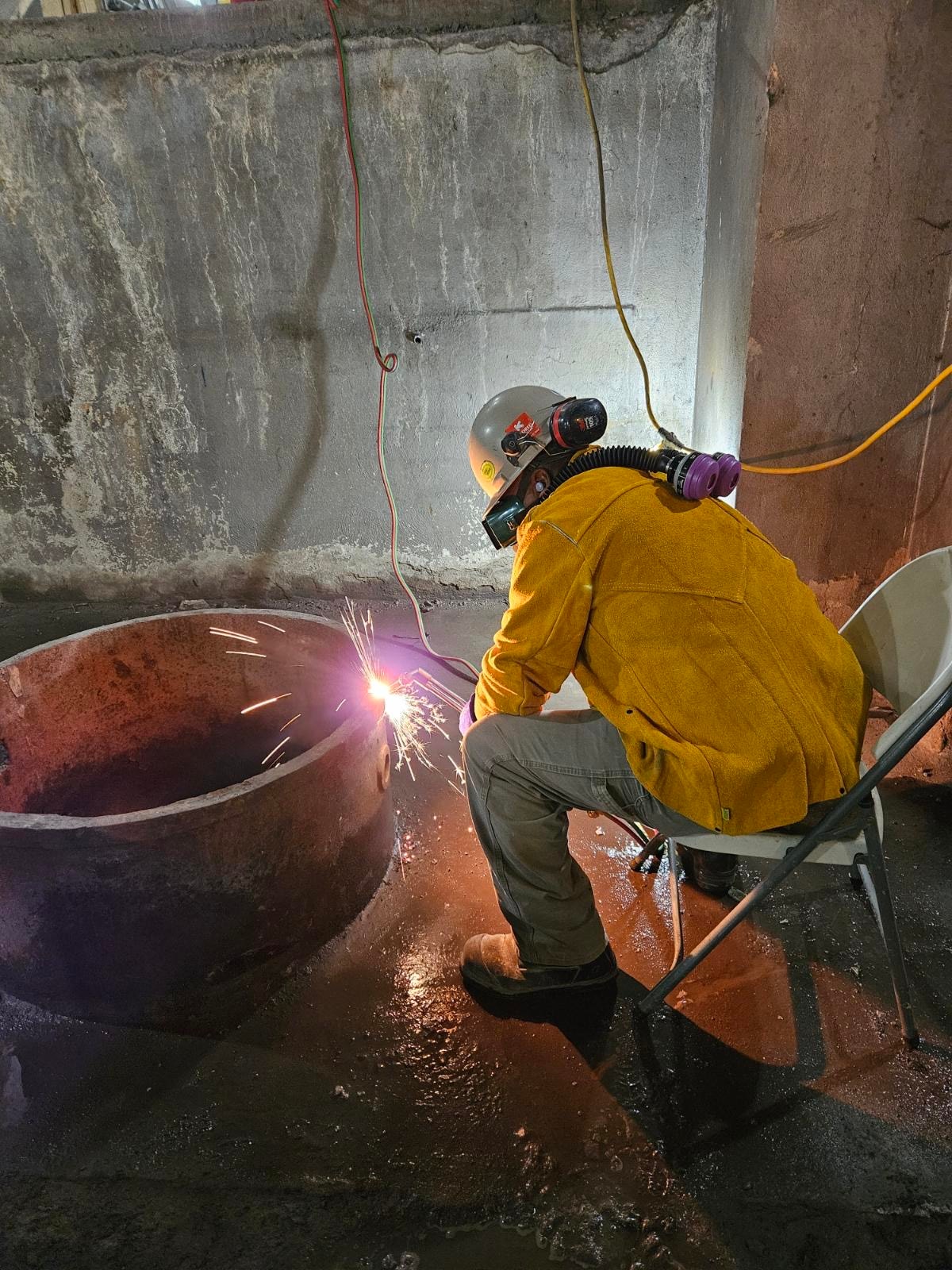 RLW worker cutting steel with sparks in underground space