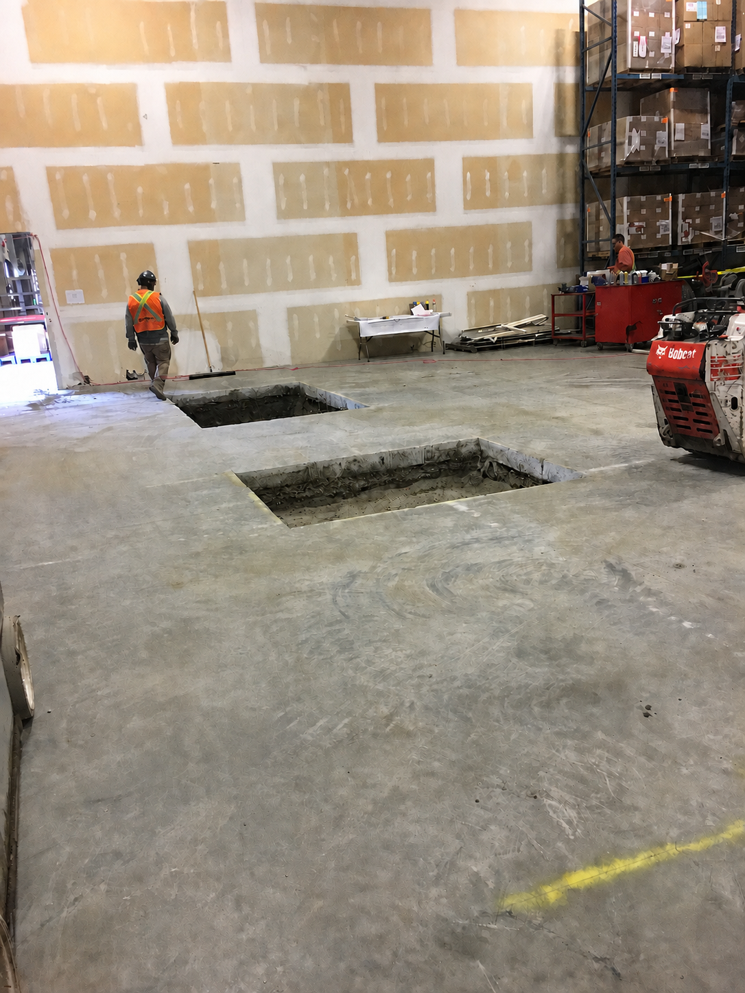 RLW crew performing concrete saw cutting and floor openings in occupied warehouse