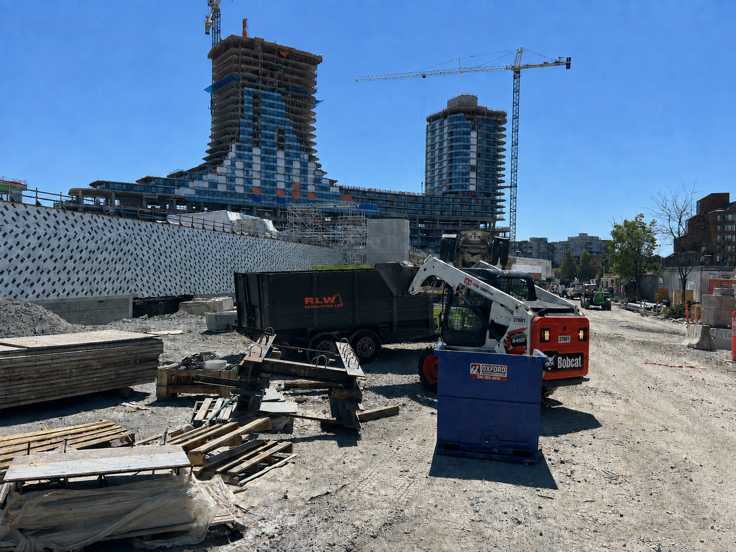 RLW Demolition Ltd Bobcat and equipment on large urban high-rise construction site