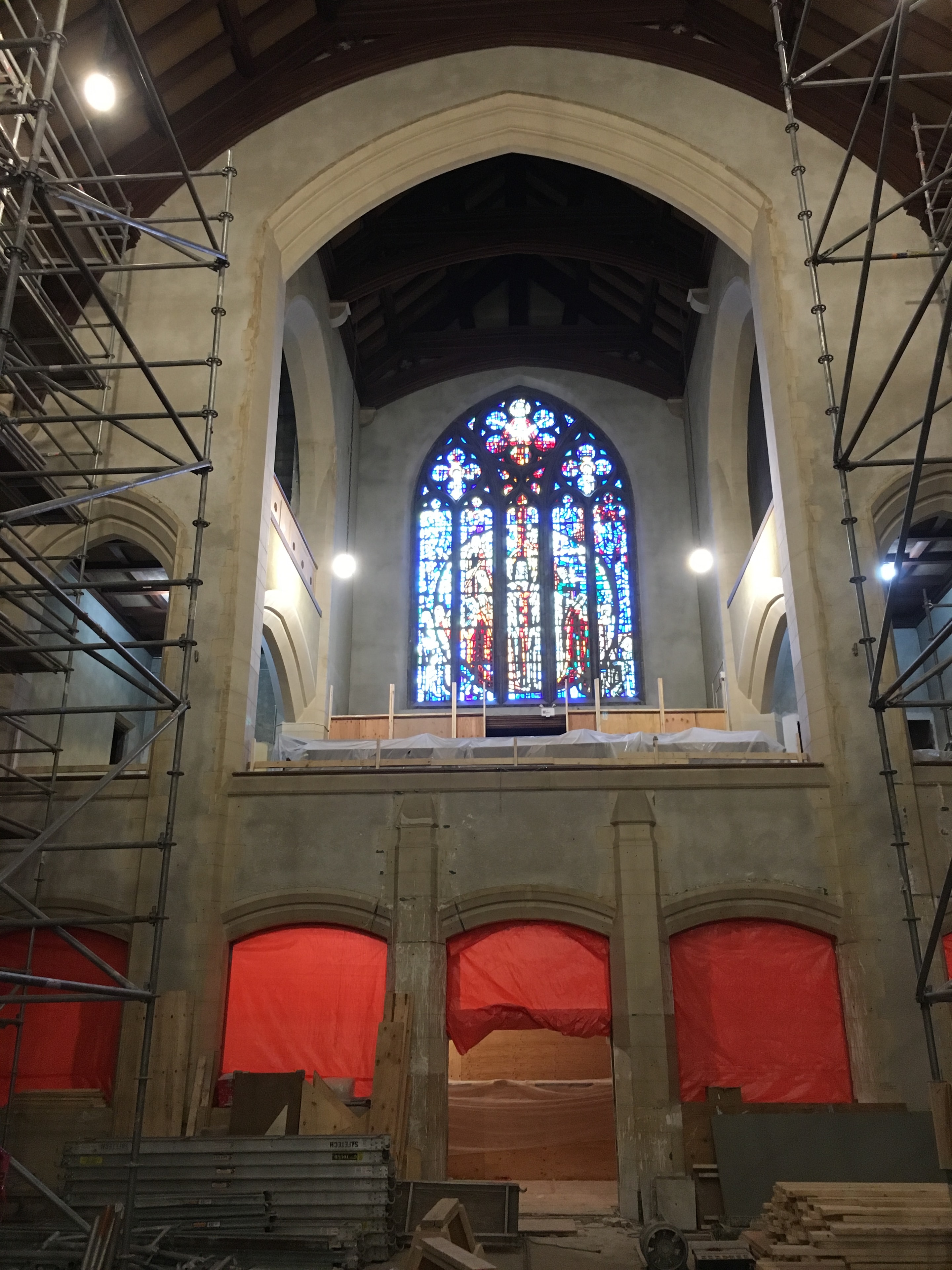 RLW demolition work inside heritage church with stained glass windows and scaffolding