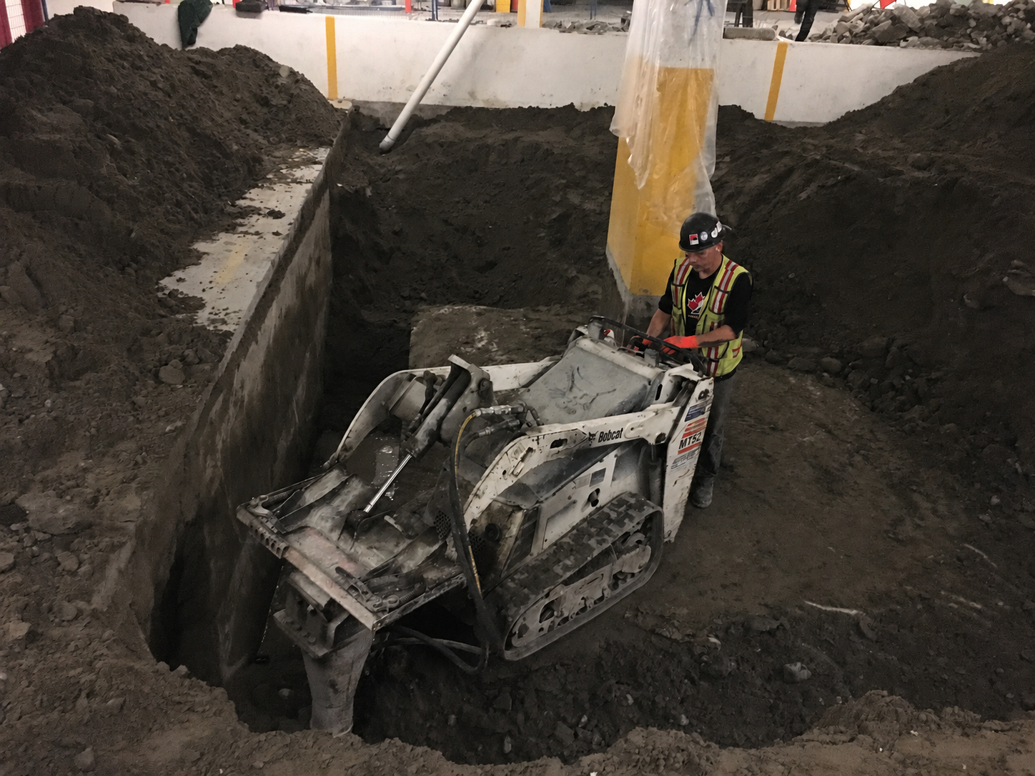RLW crew operating Bobcat MT52 in indoor excavation pit